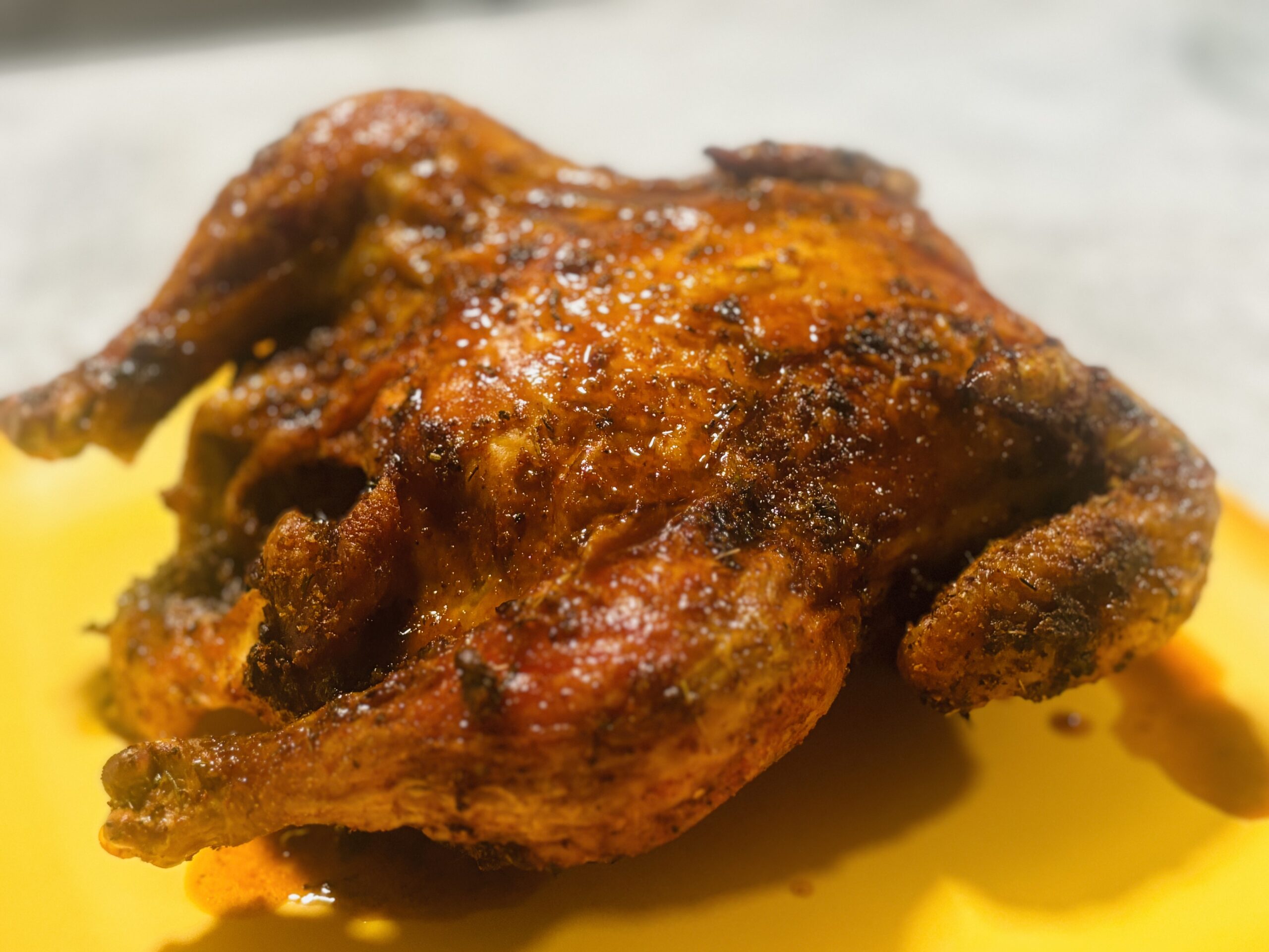 Trussed whole chicken placed on a roasting rack for even cooking